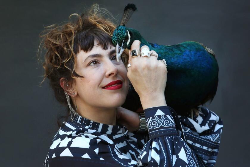 VENICE, CA-February 20, 2018: Ventiko is photographed with her peacock, Dexter, in Venice. Ventiko tried to bring her peacock Dexter on a United flight from Newark to LA. The story, about how United refused to let her âemotional support peacockâ fly in the cabin with her, went viral. Ventiko considers Dexter, who is a registered support animal, a companion, and despite the coverage, there was nothing stunt-y about her intentions. She has owned Dexter since 2014. (Katie Falkenberg / Los Angeles Times)