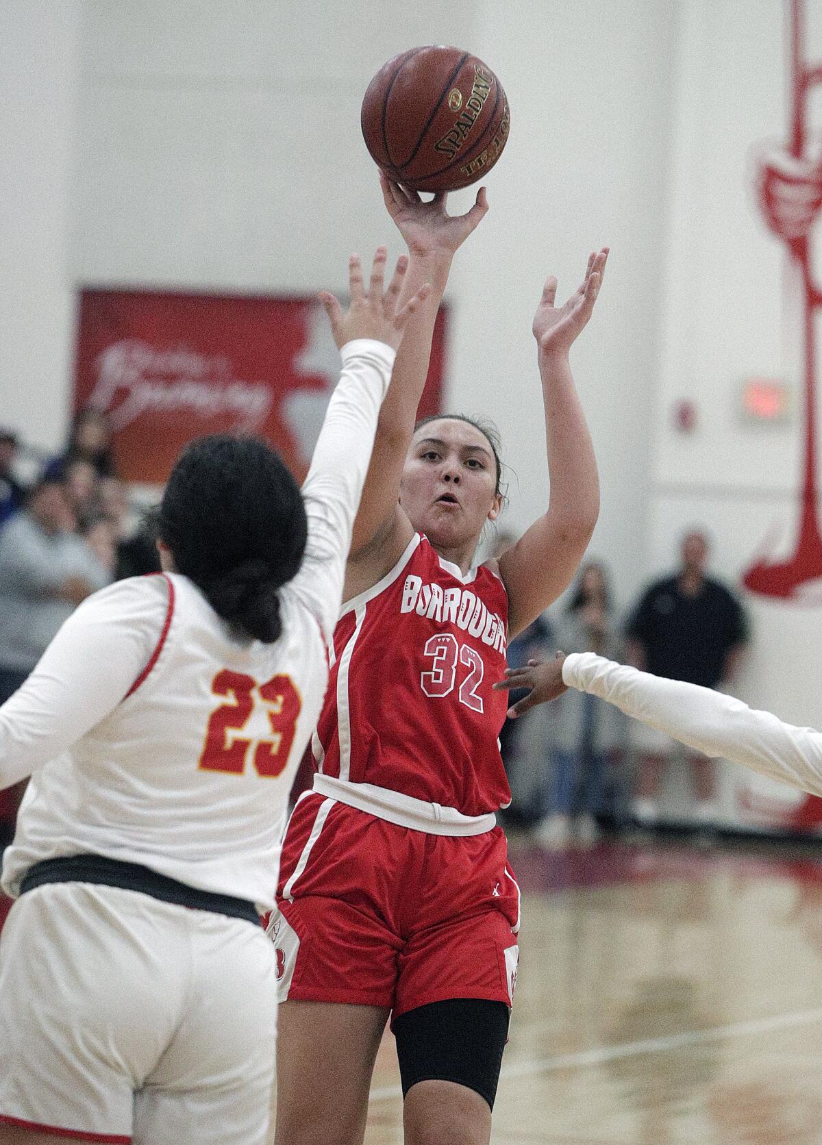 Burroughs' Faith Boulanger shoots a fade-away shot against Whittier Christian's Shelly Vasquez in the CIF Southern Section Division II-A girls' basketball quarterfinal at Whittier Christian High School in La Habra on Wednesday, February 19, 2020. Burroughs won the game 41-39, a game that was hard fought until the last points were scored