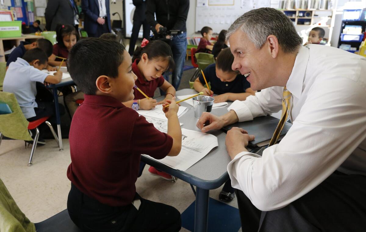 Education Secretary Arne Duncan visits with students in Denver in May.