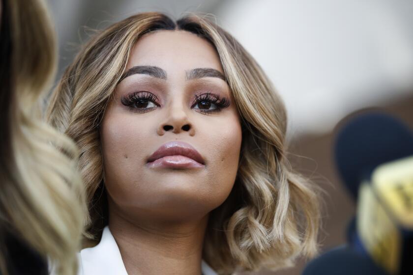Rob Kardashian's ex-fiancee Blac Chyna listens to her attorney Lisa Bloom at a news conference after a hearing Monday, July 10, 2017, in Los Angeles. A court commissioner has granted Chyna a temporary restraining order against the reality television star. (AP Photo/Jae C. Hong)