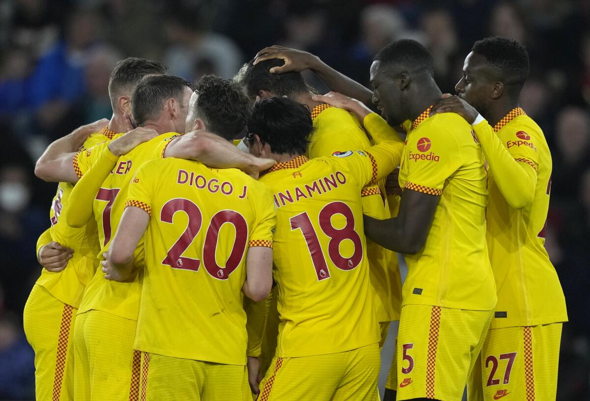 Liverpool players celebrate after Liverpool's Joel Matip scored his side's second goal during the English Premier League soccer match between Southampton and Liverpool at St. Mary's Stadium in Southampton, England, Tuesday, May 17, 2022. (AP Photo/Frank Augstein)