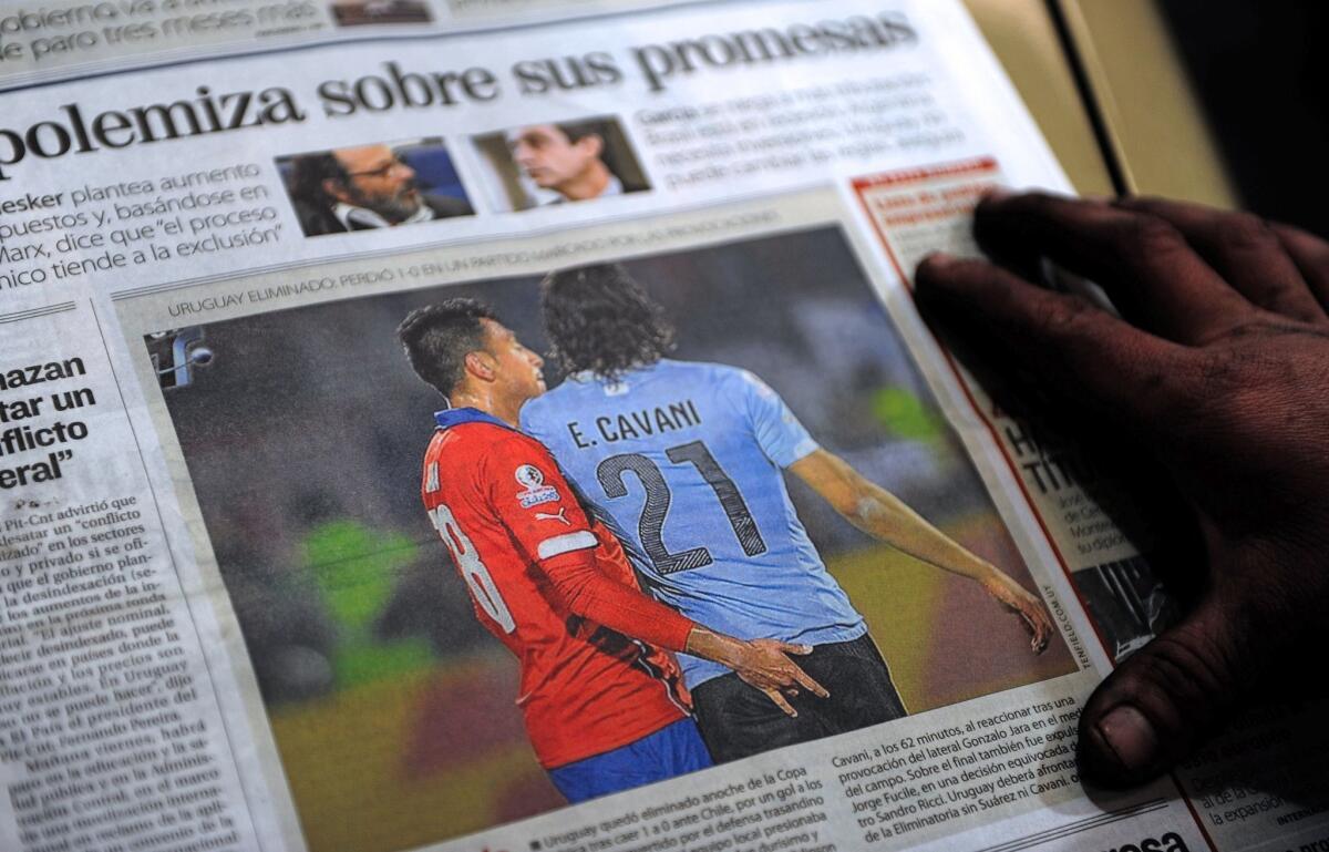 The front page of an Uruguayan newspaper shows on June 25, 2015 in Montevideo a picture of Chile's football team defender Gonzalo Jara provoking Uruguay's Edinson Cavani during their Copa America 2015 quarterfinals football match in Santiago. Cavani was sent off midway through the second half after receiving a second yellow card for flicking a hand into the face of Jara. AFP PHOTO/MIGUEL ROJOMIGUEL ROJO/AFP/Getty Images ** OUTS - ELSENT, FPG - OUTS * NM, PH, VA if sourced by CT, LA or MoD **