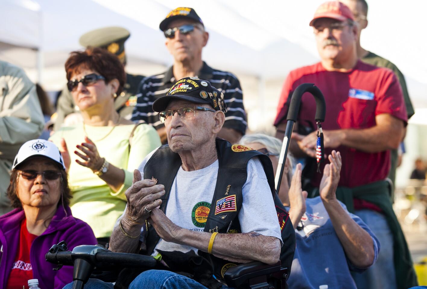Robert Buck Rogers, a U.S. Marine Corps veteran who served in World War II, Korea and Vietnam claps during the Vietnam war veterans recognition ceremony at the 2015 Orange County Veterans Day community celebration.