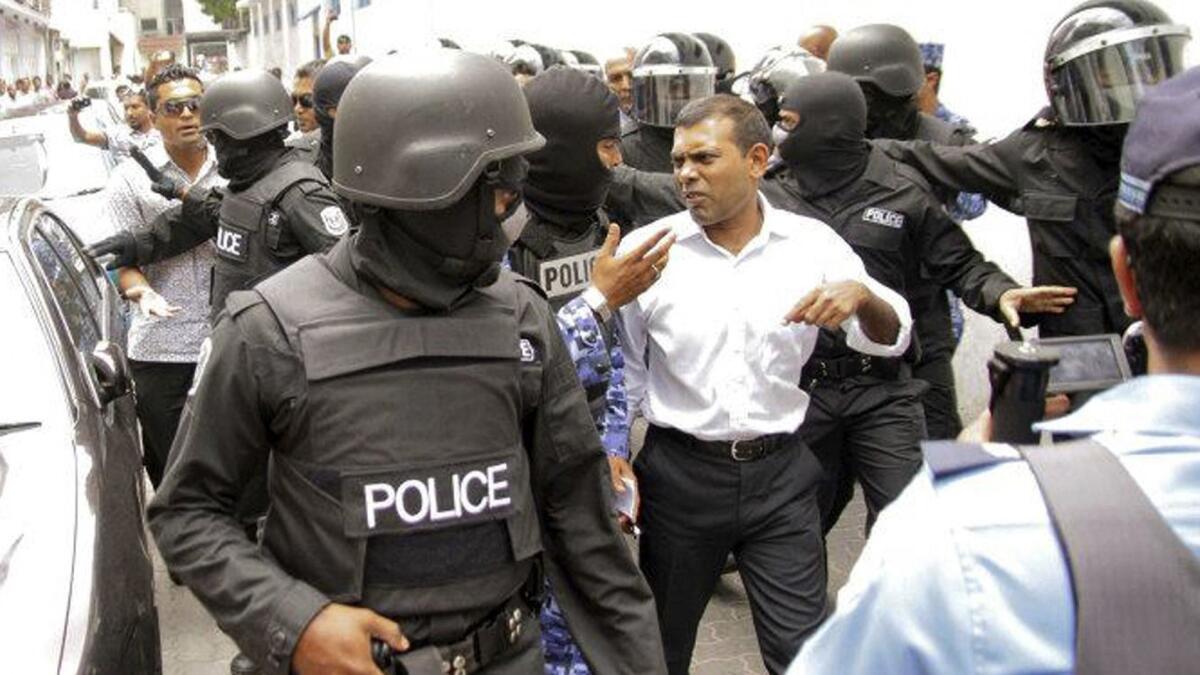Mohamed Nasheed is taken away by police after he was arrested at his home in Male, Maldives, in 2013.