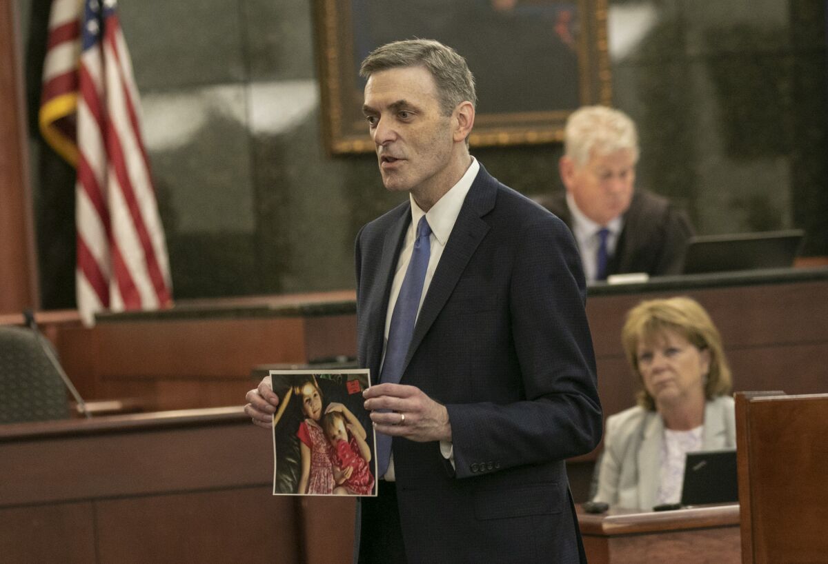 FILE - 11th Circuit Solicitor Rick Hubbard delivers closing arguments, showing pictures of the Jones children during the sentencing phase of the trial of Timothy Jones Jr. in Lexington, S.C. on Thursday, June 13, 2019. South Carolina Supreme Court justices are questioning whether a prosecutor offered to show photos of five dead children to a jury to unfairly upset them so they would sentence their father to death. The high court heard 39-year-old Timothy Jones' request to overturn his murder convictions and death sentence on Tuesday, Nov. 9, 2021. (Tracy Glantz/The State via AP, Pool, File)