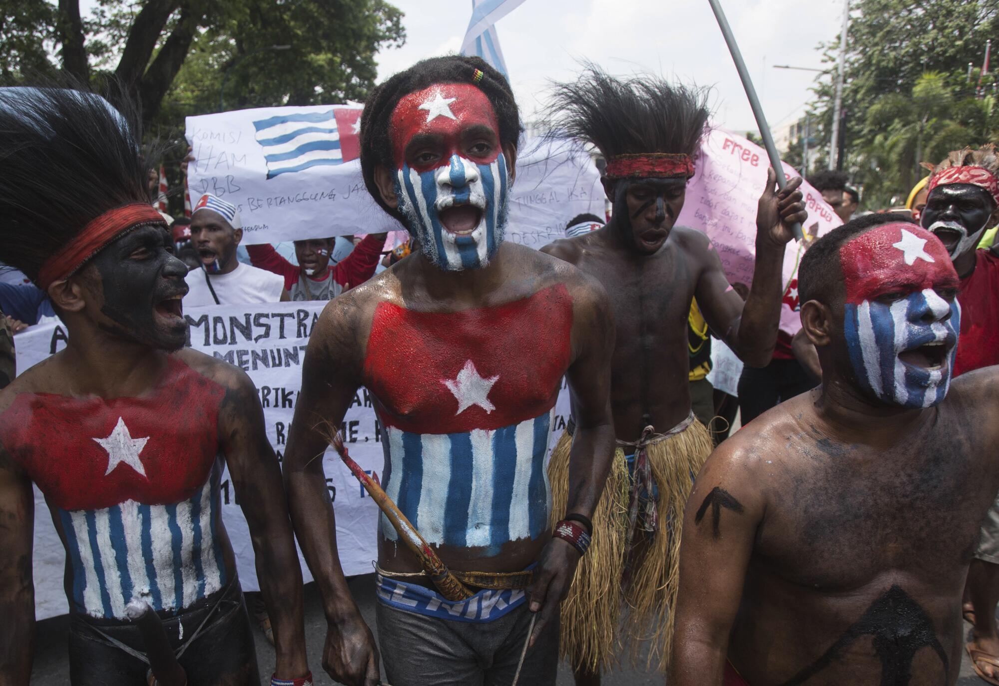 Papuan students with their bodies and faces painted with the colors of the banned separatist Morning Star flag.