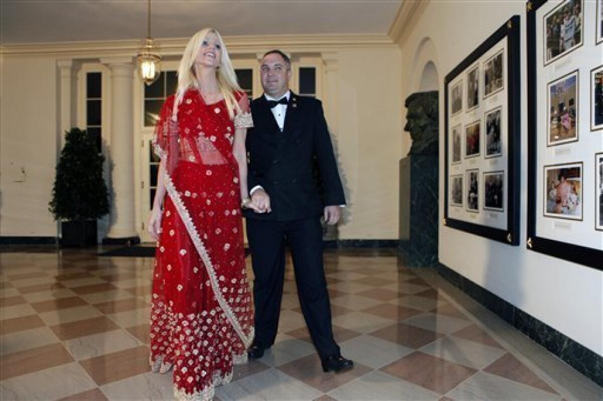 In this Tuesday, Nov. 24, 2009 photo, Michaele and Tareq Salahi, right, arrive at a state dinner hosted by President Barack Obama for Indian Prime Minister Manmohan Singh at the White House in Washington. The Secret Service is looking into its own security procedures after determining that the Virginia couple managed to slip into Tuesday night's state dinner at the White House even though they were not on the guest list, agency spokesman Ed Donovan said. (AP Photo/Gerald Herbert)