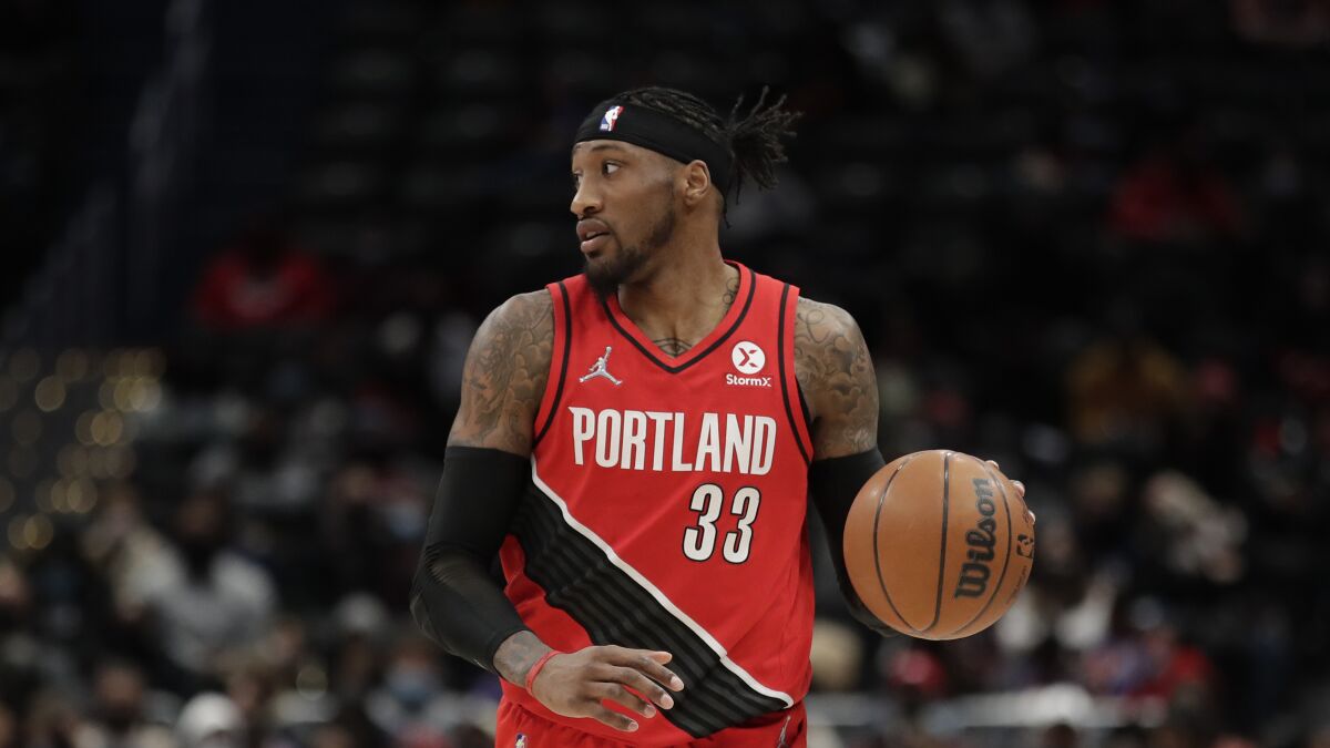 Robert Covington brings the ball up court while playing for the Trail Blazers.