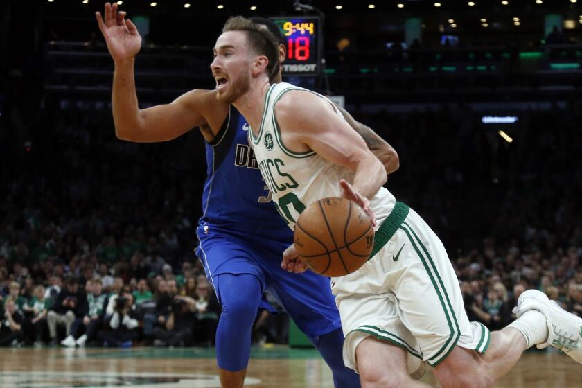 Boston Celtics forward Gordon Hayward (20) drives by Dallas Mavericks guard Devin Harris during the fourth quarter of an NBA basketball game, Friday, Jan. 4, 2019, in Boston. The Celtics won 114-93. (AP Photo/Elise Amendola)