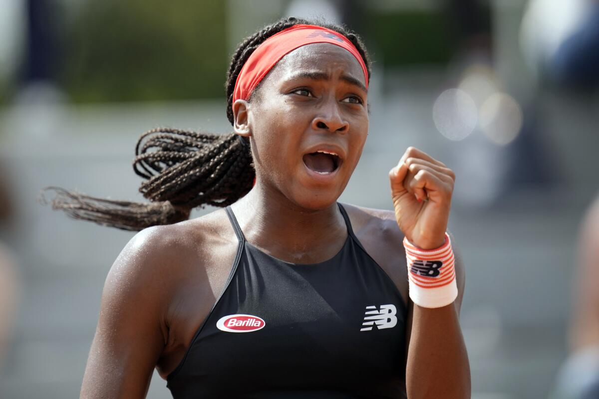 FILE - In this June 3, 2021, file photo, Coco Gauff, of the United States, celebrates after winning a point against China's Qiang Wang during their second round match at the French Open tennis tournament at Roland Garros in Paris, France. The teen tennis sensation said Thursday, Aug. 5, 2021, that she was supposed to get her first vaccine shot the same week she got COVID-19, which forced her to pull out of the Tokyo Olympics and has left her without her sense of smell. (AP Photo/Christophe Ena)