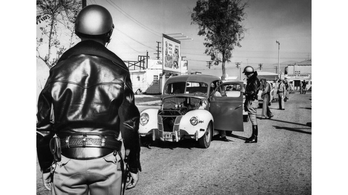 Dec. 20, 1957: California Highway Patrol officers halt cars on Whittier Boulevard during a holiday campaign to keep drunk drivers and defective automobiles off the roads.