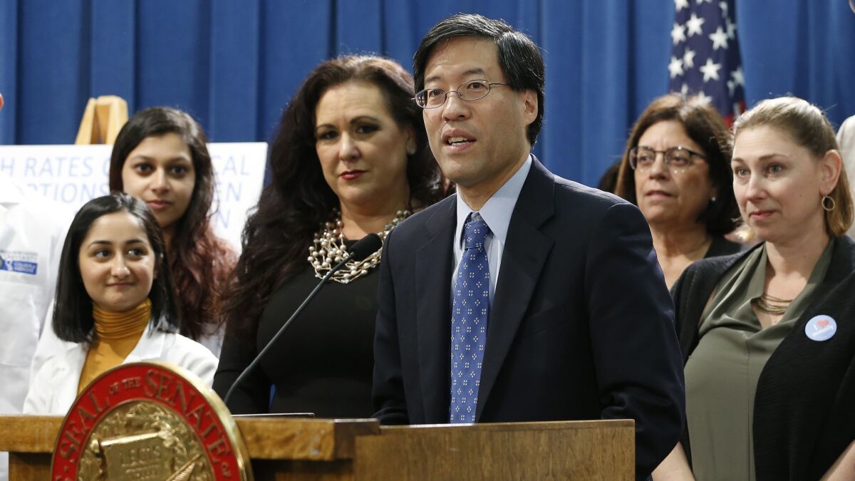 State Sen. Richard Pan, center, discusses his proposed measure to tighten California's law requiring childhood vaccinations.