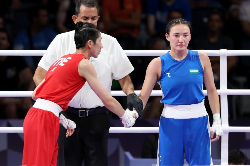 PARIS, FRANCE August 2, 2024-Taipei's Yu Ting Lin, red, shakes hands with Uzebekistan's Sitora Turdibekova as she looks away in the 57kg boxing match at the 2024 Paris Olympics Friday. (Skalij/Los Angeles Times)