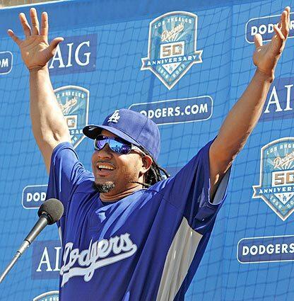 Manny Ramirez greets the media after arriving at Dodger Stadium on Friday afternoon. The slugger will wear No. 99 when he takes the field against the Arizona Diamondbacks.