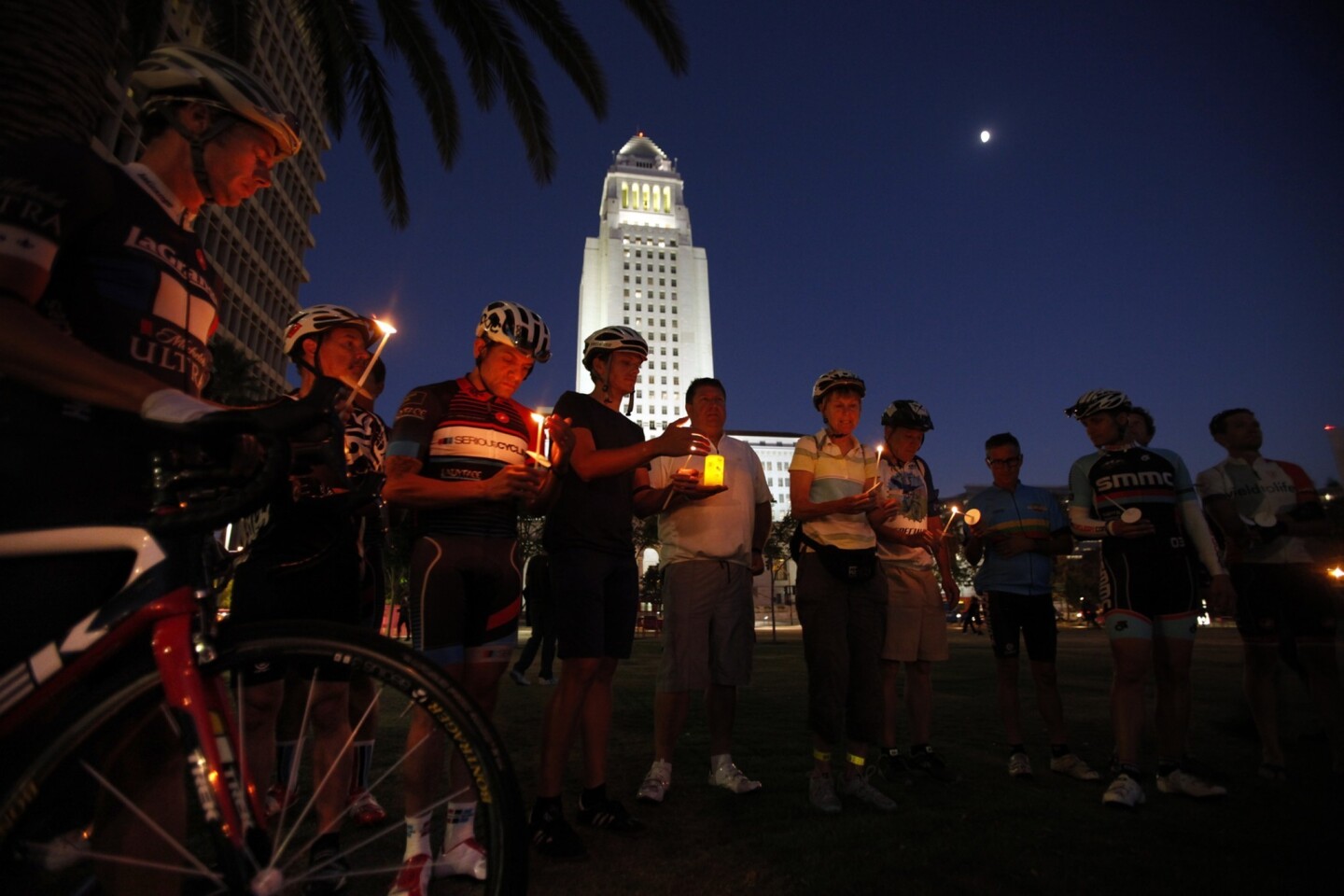 Cyclists hold a candlelight vigil for ex-Napster executive Milton Olin Jr. Deputy Andrew Francis Wood wasn't charged with killing Olin because police are exempt from a state law banning drivers from using wireless electronic devices.