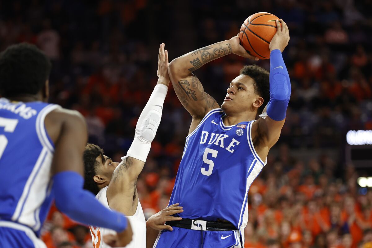 Duke forward Paolo Banchero (5) shoots over Clemson guard David Collins (13) during the first half of an NCAA college basketball game in Clemson, S.C., Thursday, Feb. 10, 2022. (AP Photo/Nell Redmond)