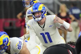 Los Angeles Rams quarterback Carson Wentz (11) lines up against the Arizona Cardinals during the first half of an NFL football game, Sunday, Nov. 26, 2023, in Glendale, Ariz. (AP Photo/Rick Scuteri)