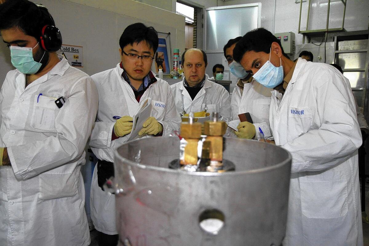 International Atomic Energy Agency inspectors and Iranian technicians are on hand to cut the connections between the twin cascades for 20% uranium enrichment at the Natanz nuclear facility in Iran.