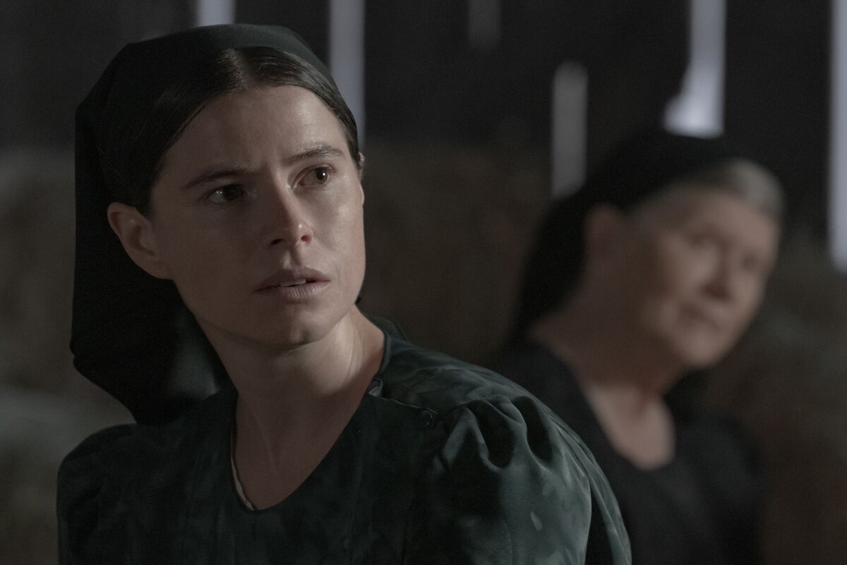 Two Mennonite women (played by Jessie Buckley and Judith Ivey) in a serious discussion in a barn in the drama "Women Talking"