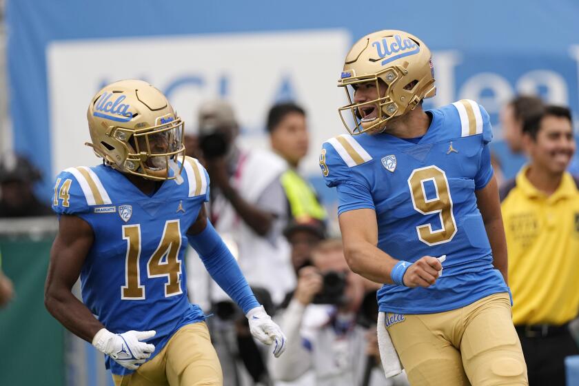 UCLA quarterback Collin Schlee, right, celebrates his touchdown with defensive back Clint Stephens during the first half of an NCAA college football game against North Carolina Central Saturday, Sept. 16, 2023, in Pasadena, Calif. (AP Photo/Mark J. Terrill)