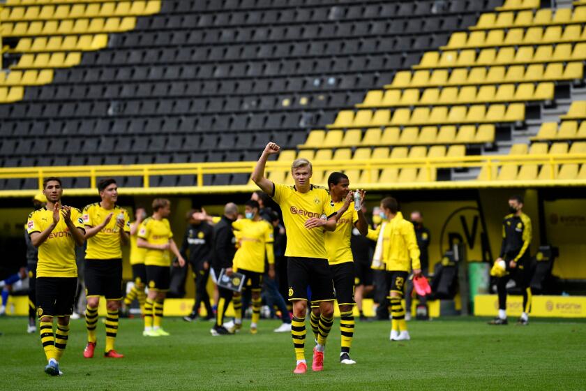 DFL regulations prohibit any use of photographs as image sequences and/or quasi-video. Mandatory Credit: Photo by MARTIN MEISSNER/POOL/EPA-EFE/REX (10648741bo) Dortmund's Erling Haaland (C) and his teammates celebrate winning the German Bundesliga soccer match between Borussia Dortmund and Schalke 04 in Dortmund, Germany, 16 May 2020. The German Bundesliga and Second Bundesliga are the first professional leagues to resume the season after the nationwide lockdown due to the ongoing Coronavirus (COVID-19) pandemic. All matches until the end of the season will be played behind closed doors. Borussia Dortmund vs Schalke 04, Deu - 16 May 2020 ** Usable by LA, CT and MoD ONLY **