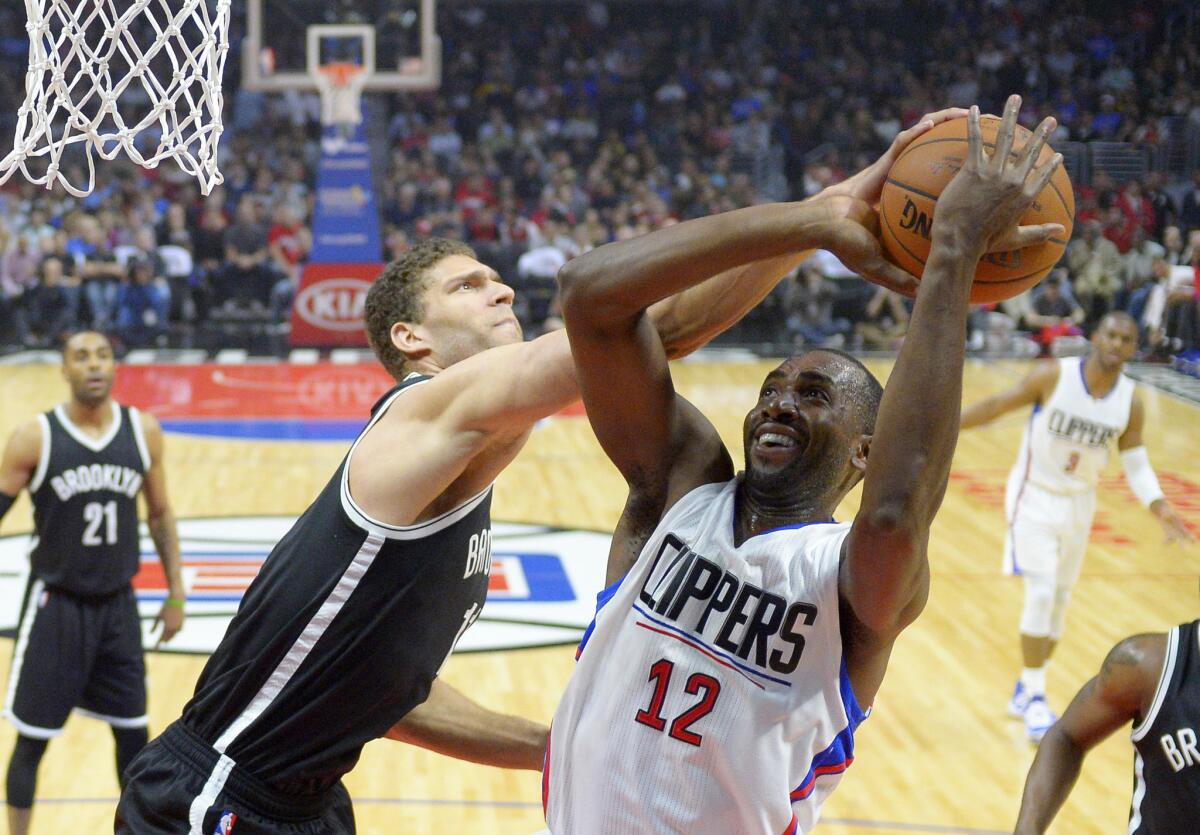 Nets center Brook Lopez, left, tries to block a shot by Clippers forward Luc Mbah a Moute on Feb. 29.
