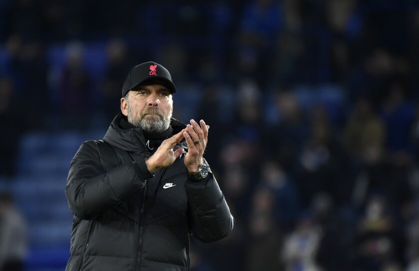 Liverpool's manager Jurgen Klopp applauds to fans at the end of the English Premier League soccer match between Leicester City and Liverpool at the King Power Stadium in Leicester, England, Tuesday, Dec. 28, 2021. (AP Photo/Rui Vieira)