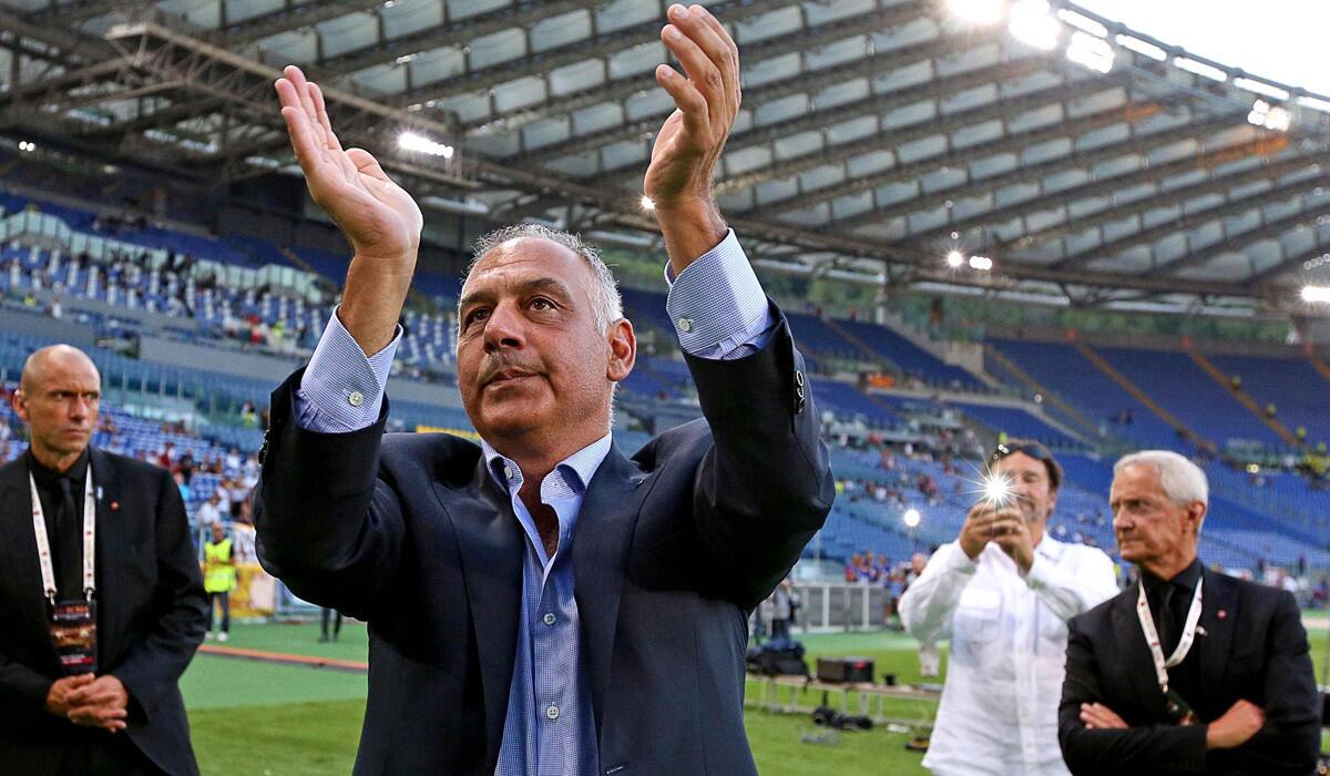 Boston businessman James Pallotta, president of AS Roma, greets fans as he arrives at Olimpico Stadium for the team's season-opening game against Fiorentina on Saturday.