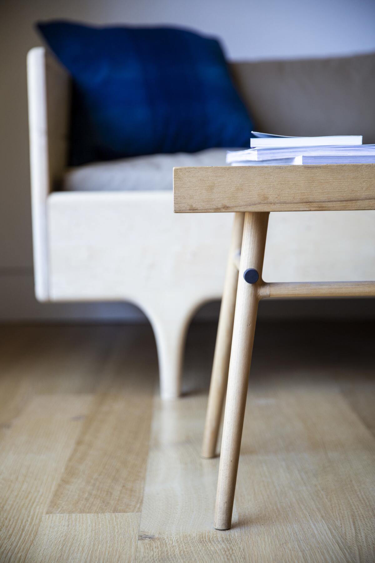 Two examples of the designers' work are on display at the couple's Highland Park home: a Bough bench that they use as a coffee table (foreground) and a divan from Kalon's Caravan collection.