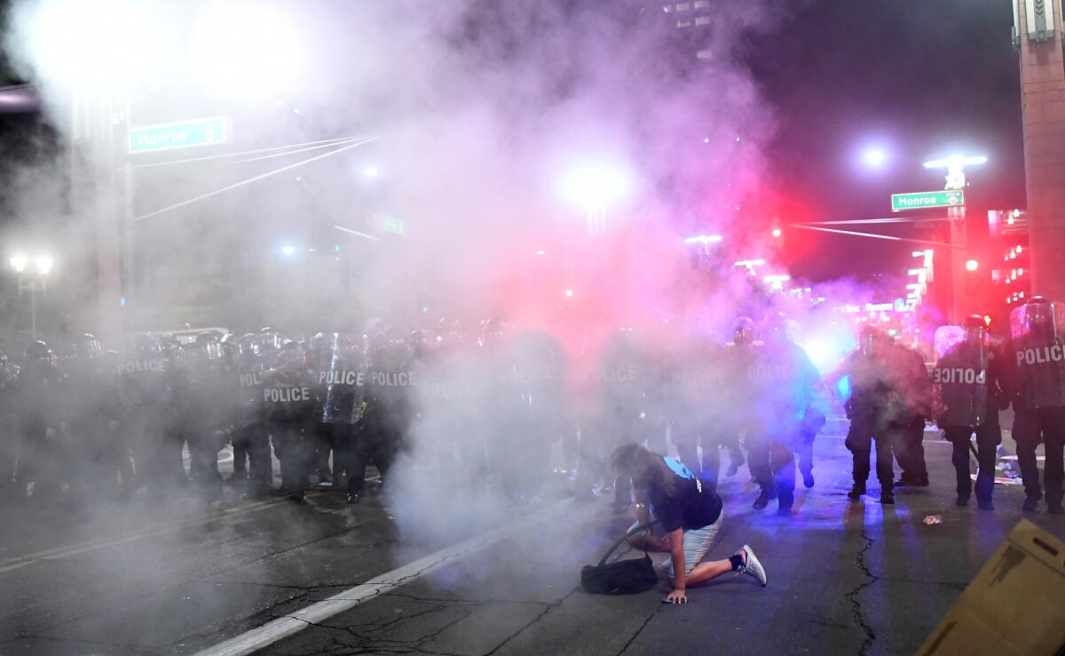 Police use tear gas against protesters outside the Phoenix Convention Center following a campaign-style rally by President Trump.