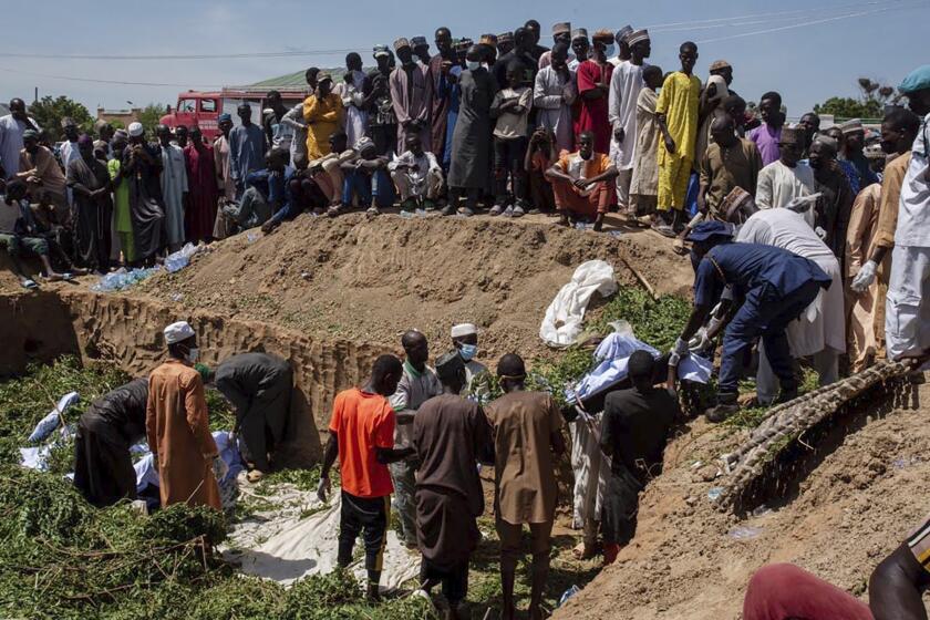 People prepare bodies for funeral following a tanker explosion in Majiya town, Nigeria, Wednesday, Oct.16, 2024. ( AP Photo/ Sani Maikatanga)