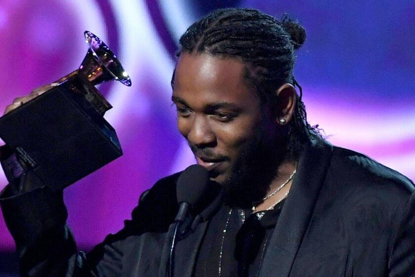 (FILES) In this file photo taken on January 28, 2018, Kendrick Lamar receives the Grammy for the Best Rap Album for "DAMN" during the 60th Annual Grammy Awards show in New York. Lamar was awarded the 2018 Pulitzer Prize for Music for DAMN. on April 18, 2016, making it the first hip-hop album to receive the prestigious prize. / AFP PHOTO / Timothy A. CLARYTIMOTHY A. CLARY/AFP/Getty Images ** OUTS - ELSENT, FPG, CM - OUTS * NM, PH, VA if sourced by CT, LA or MoD **