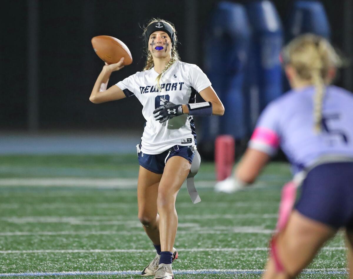 Newport Harbor quarterback Scarlett Guyser (9) makes a completion against Corona del Mar on Monday.