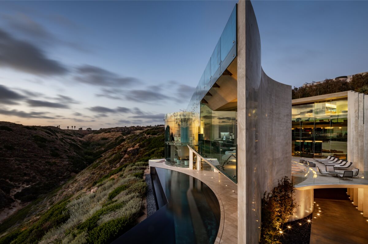 Built in 2007, the 11,500-square-foot modern mansion takes in sweeping ocean views from window-lined living spaces, rooftop terraces and a custom concrete courtyard.