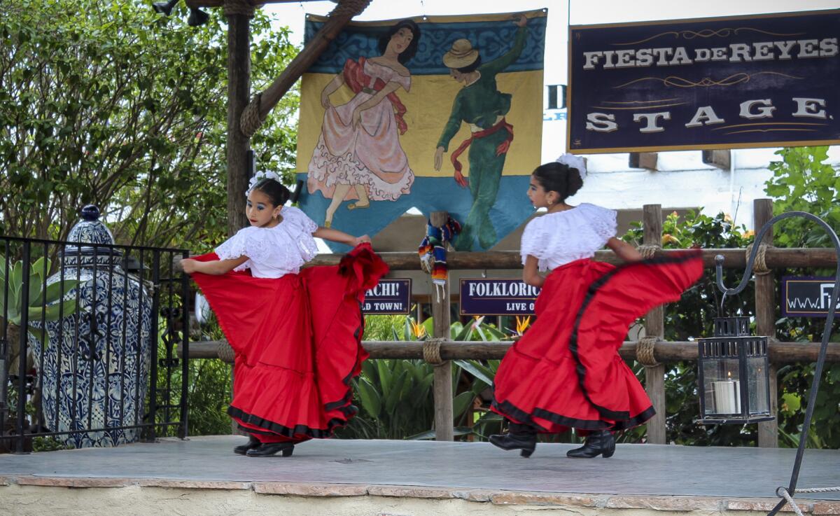 Young folklorico dancers perform in the courtyard of Fiesta de Reyes in San Diego's Old Town. Tacos and churros are just steps away. (Jan Molen / Los Angeles Times)