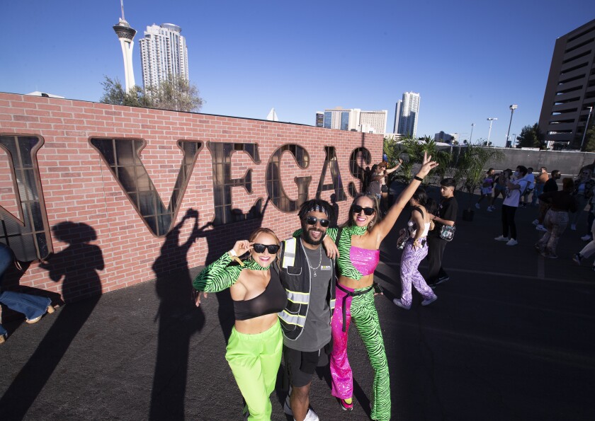 Fans pose in front of the Day N Vegas sign at the first music festival since the tragedy at Astroworld.