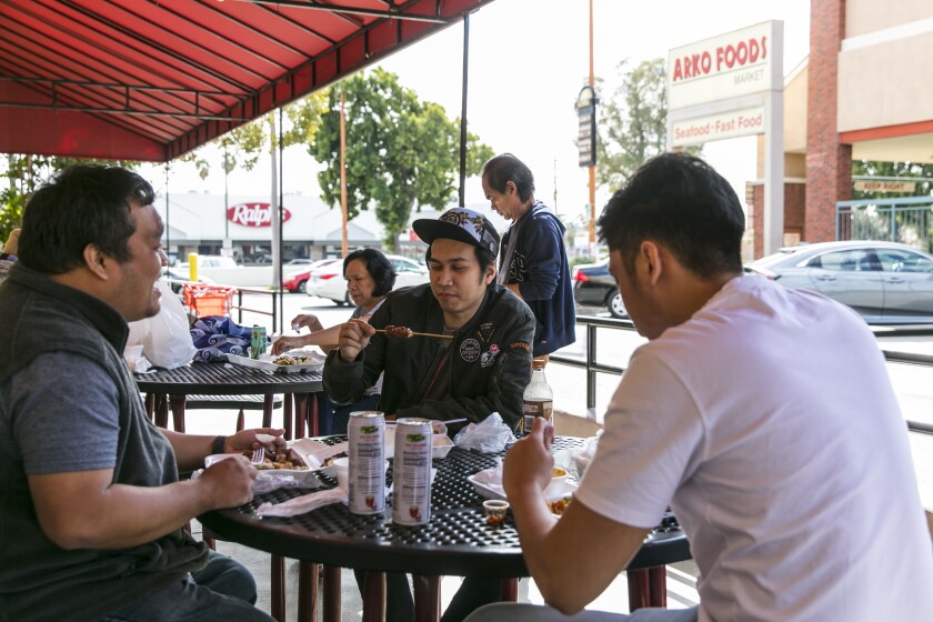Customers enjoy a lunch on the patio at Arko Foods International.