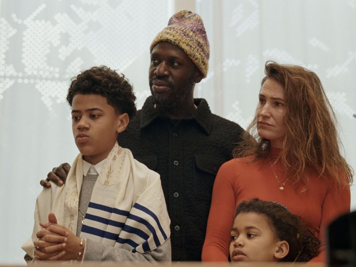 A family stands in a synagogue in Amsterdam.