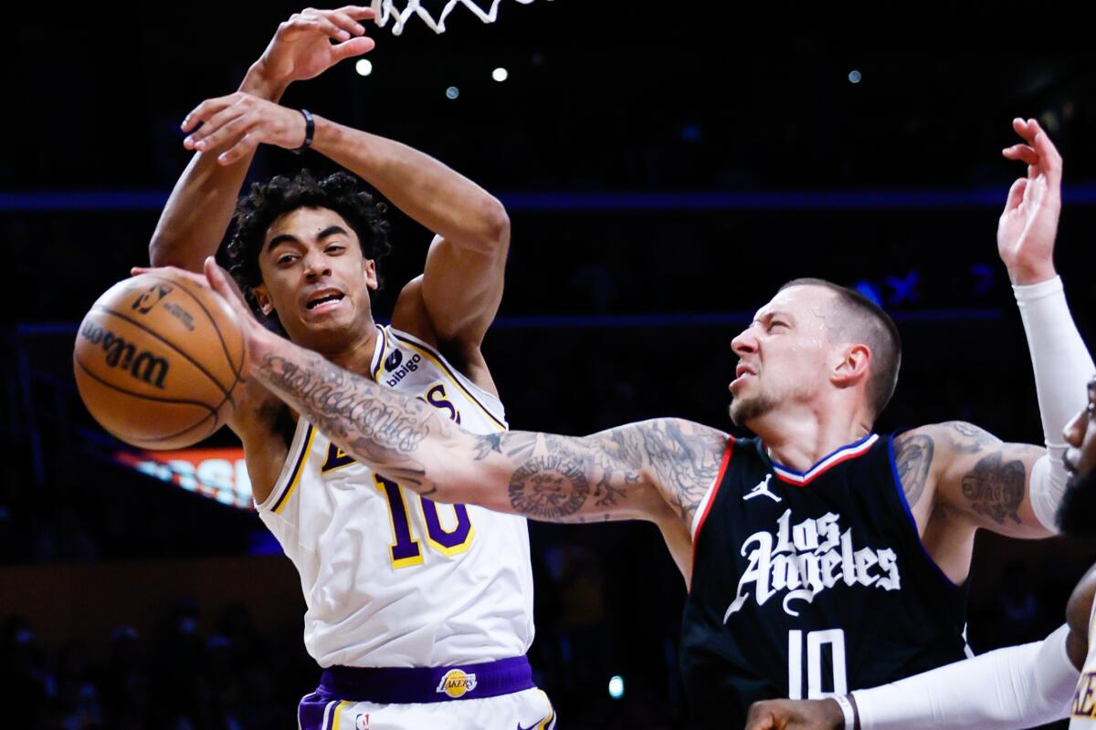 Lakers guard Max Christie, left, and Clippers center Daniel Theis battle for a rebound in the first half Sunday.