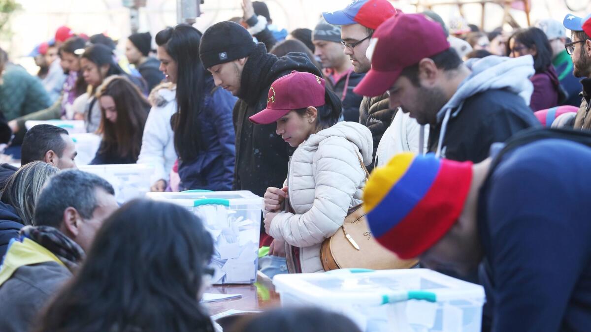Venezuelans in Santiago, Chile, assembled in July to vote on an unofficial referendum to express their views on a plan by President Nicolas Maduro to rewrite the Venezuelan constitution.