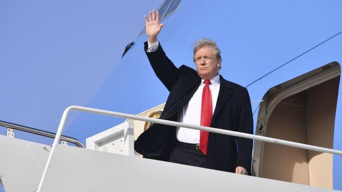 President Trump waves before boarding Air Force One for a campaign trip to Michigan on March 28.