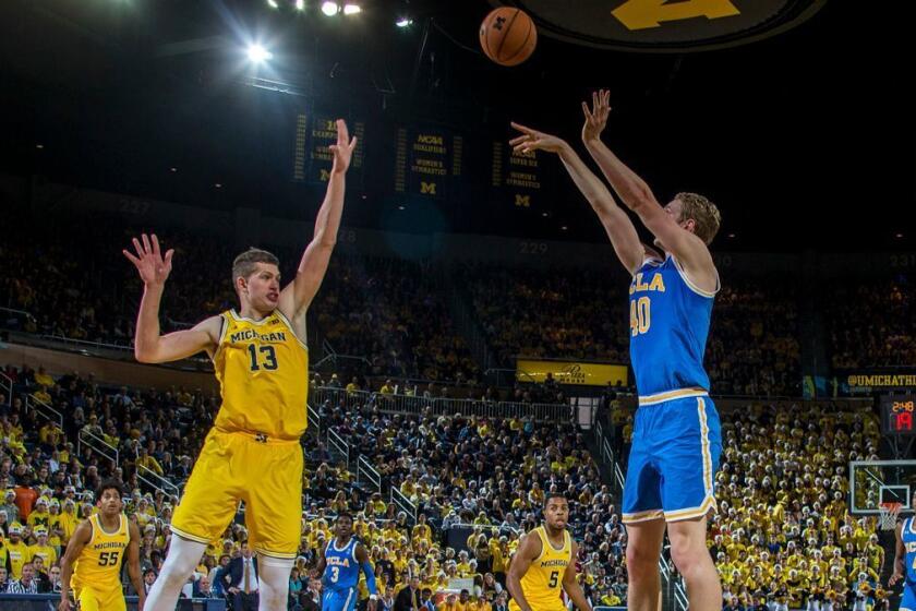 Michigan forward Moritz Wagner (13) defends a jump shot attempt from UCLA center Thomas Welsh (40) in the first half of an NCAA college basketball game at Crisler Center in Ann Arbor, Mich., Saturday, Dec. 9, 2017. (AP Photo/Tony Ding)
