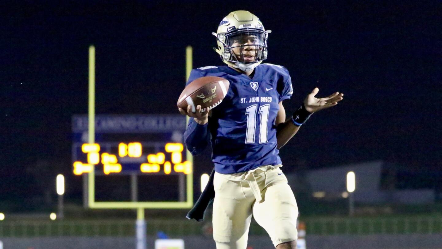 St. John Bosco quarterback Re-al Mitchell walks into the end zone untouched on a read option keeper during a game against Chaminade on Sept. 8.