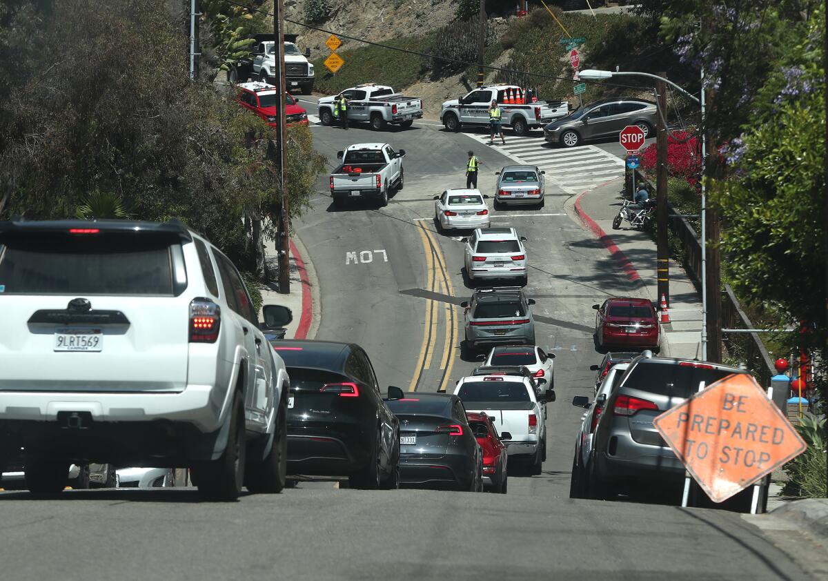 Traffic begins to back up along Bluebird Canyon Drive below Rancho fire on Monday afternoon