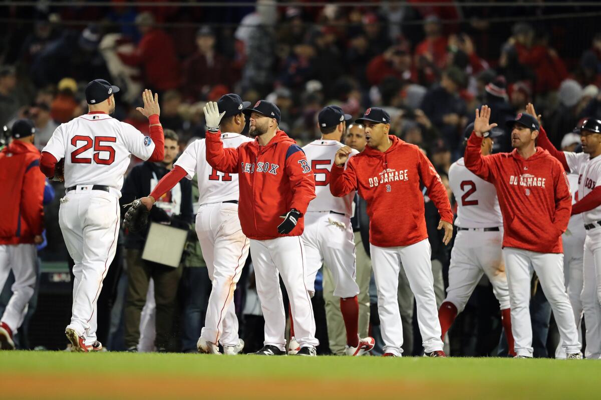 The Boston Red Sox celebrate their win over the Houston Astros in Game Two of the American League Championship Series at Fenway Park on October 14, 2018 in Boston, Massachusetts. The Red Sox defeated the Astros 7-5.