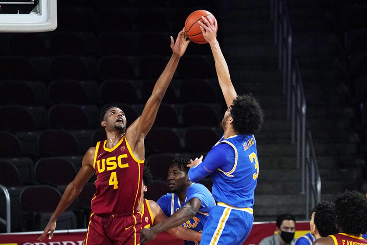 USC's Evan Mobley defends against UCLA's Johnny Juzang during a game in February. 