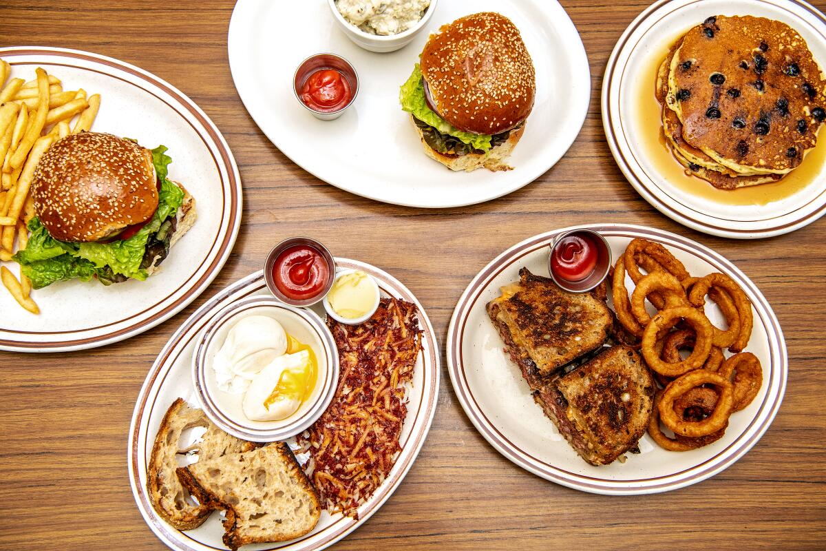 An array of dishes at Clark Street Diner, including cheeseburgers and blueberry pancakes
