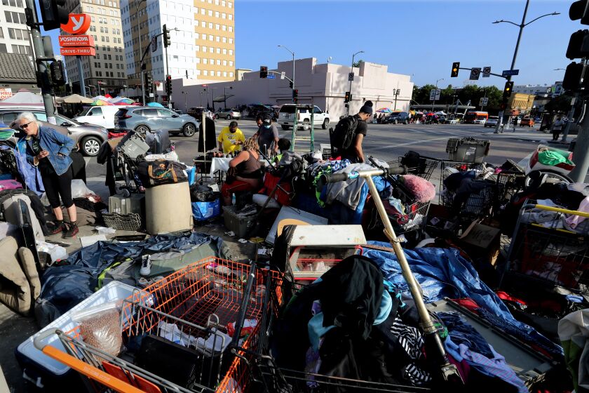 LOS ANGELES, CA - JULY 01:. A homeless encampment encroaches on the sidewalk at the intersection of Wilshire Boulevard and Alvarado Street in MacArthur Park in Los Angeles. (Luis Sinco / Los Angeles Times)