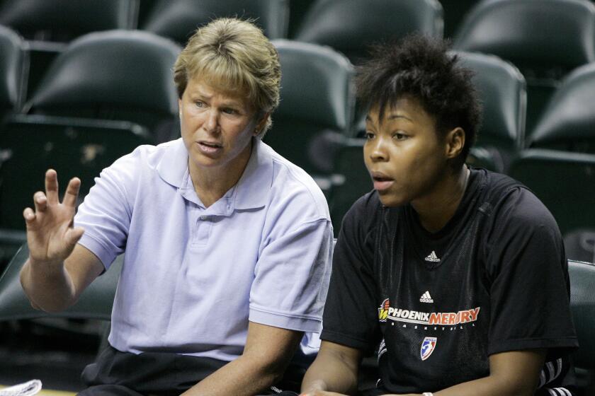 FILE - Phoenix Mercury general manager Ann Meyers Drysdale, left, talks with forward Cappie Pondexter.