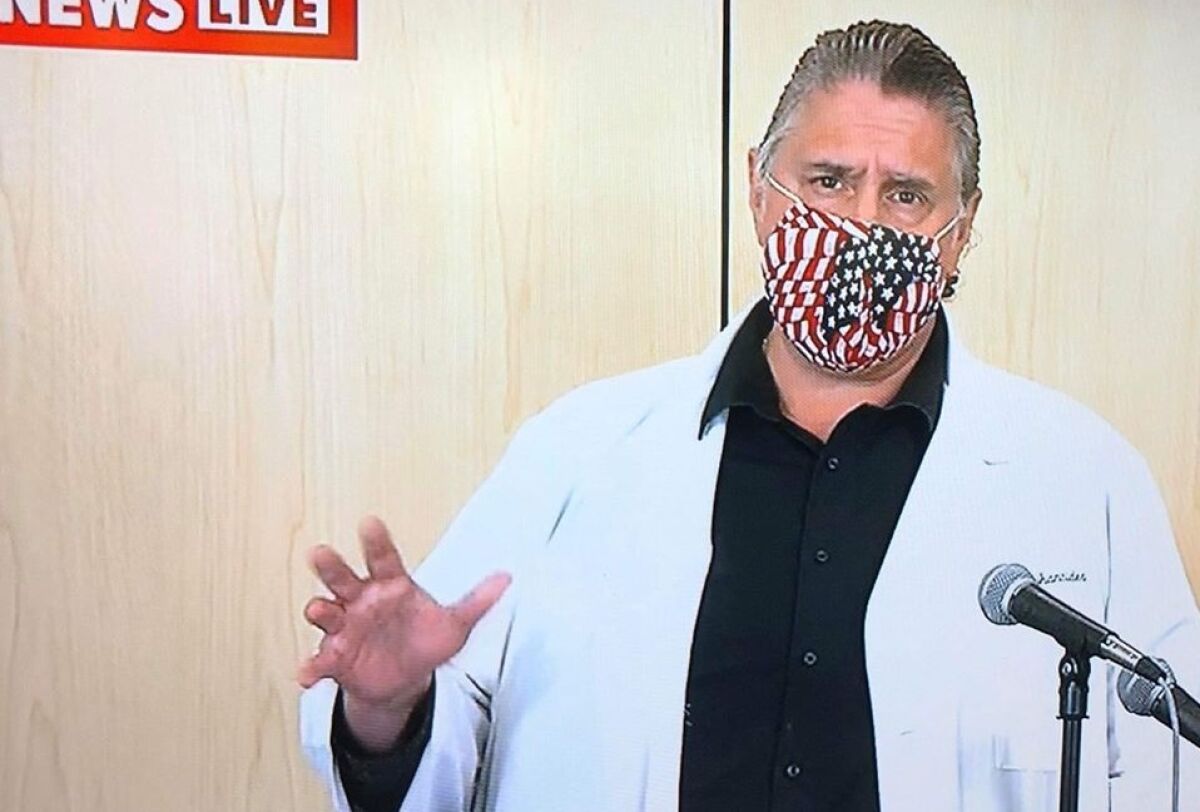 Practicing what he preaches, San Diego County Chief Medical Officer Nick Yphantides wears a mask that was made by a family friend while addressing the media about COVID-19.